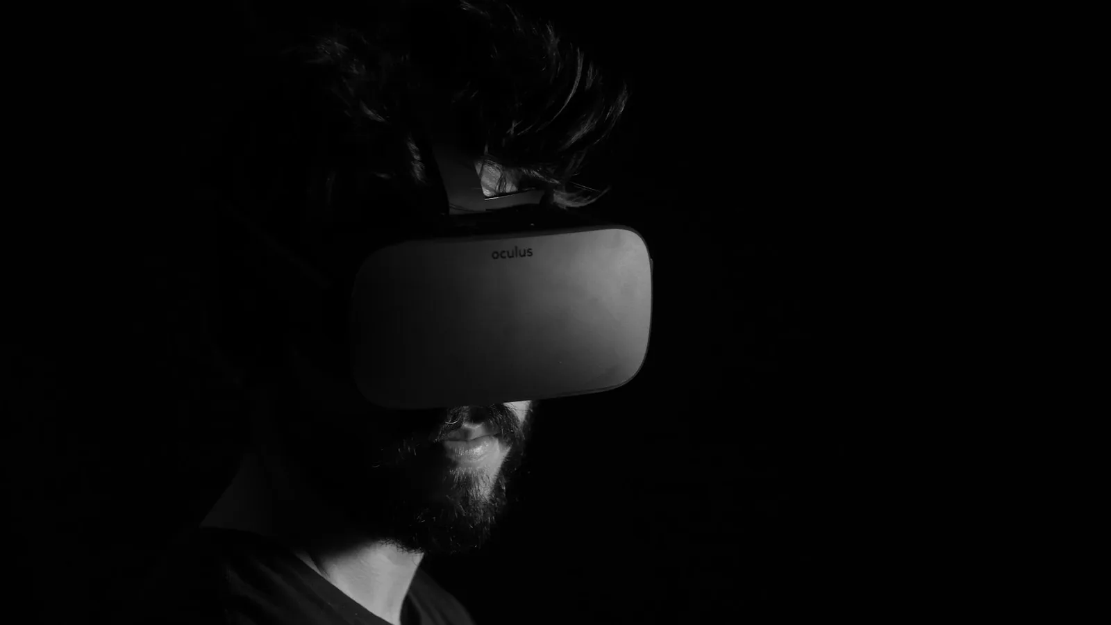 Person wearing a virtual reality headset in a dark room